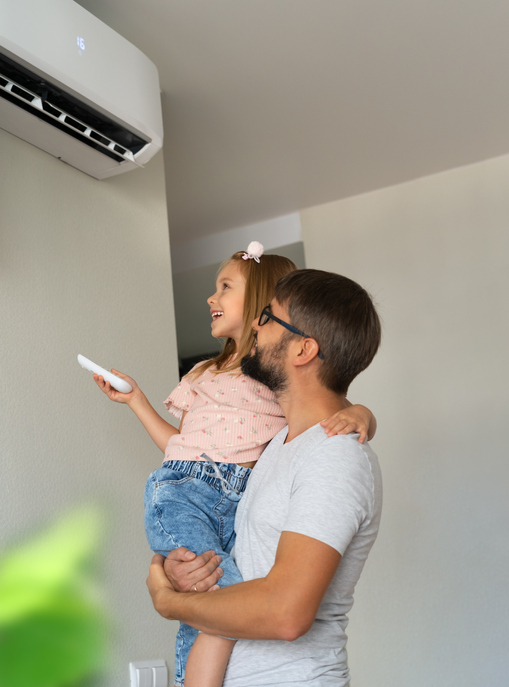 Happy family, father and little daughter fun turn on air conditioner using remote control. Cooler system